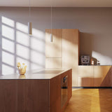 Twee Expo hanglampen van sackit boven een moderne houten keuken met warme verlichting en strakke kasten in een stijlvol Scandinavisch interieur