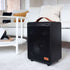 Zwarte draagbare bluetoothspeaker van sackit met handvat in een modern Scandinavisch interieur naast een witte salontafel en bank