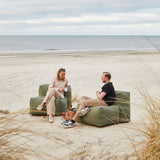 Soft Sofa Outdoor 2 Seater in Kirra Olive van sackit in een buitenomgeving