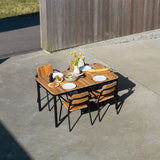 Kirra Dining Table 150x90 in Noir van sackit op een terras