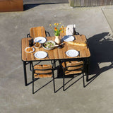 Kirra Dining Table & 4 Kirra Patio Chair in Noir van sackit in een buitenomgeving
