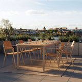Kirra Dining Table & 6 Kirra Patio Chair in Taupe van sackit in een buitenomgeving