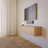 sackit soundbar onder een aan de muur gemonteerde televisie in een stijlvol interieur met zwevend houten tv meubel en neutrale tinten