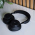 Zwarte Touch 400 over ear hoofdtelefoon van sackit met brede hoofdband en zachte oorkussens op een lichte tafel naast een plant