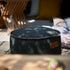 Zwarte ronde outdoor poef van sackit met stevige bekleding en decoratieve stikrand voor gebruik als voetensteun of extra zitplaats in de tuin en woonkamer