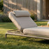 Elegante Kirra sunbed van sackit met verstelbare rugleuning en zacht beige kussen in een groene tuin ontworpen voor ontspannen momenten buiten