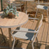 Kirra Cafe Table & 2 Kirra Patio Chair in Taupe van sackit buiten bij natuurlijk licht