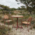 Kirra Cafe Table & 2 Kirra Patio Chair in Chestnut van sackit op een terras