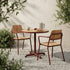 Kirra Cafe Table & 2 Kirra Patio Chair in Chestnut van sackit in een ontspannen loungehoek buiten
