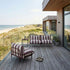 Mollis Lounge Chair in Renesse Chestnut van sackit in een buitenomgeving