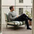 Mollis Lounge Chair in Renesse Olive van sackit op een terras