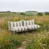 Mollis Lounge Sofa 2 Seater in Renesse Taupe van sackit in een buitenomgeving
