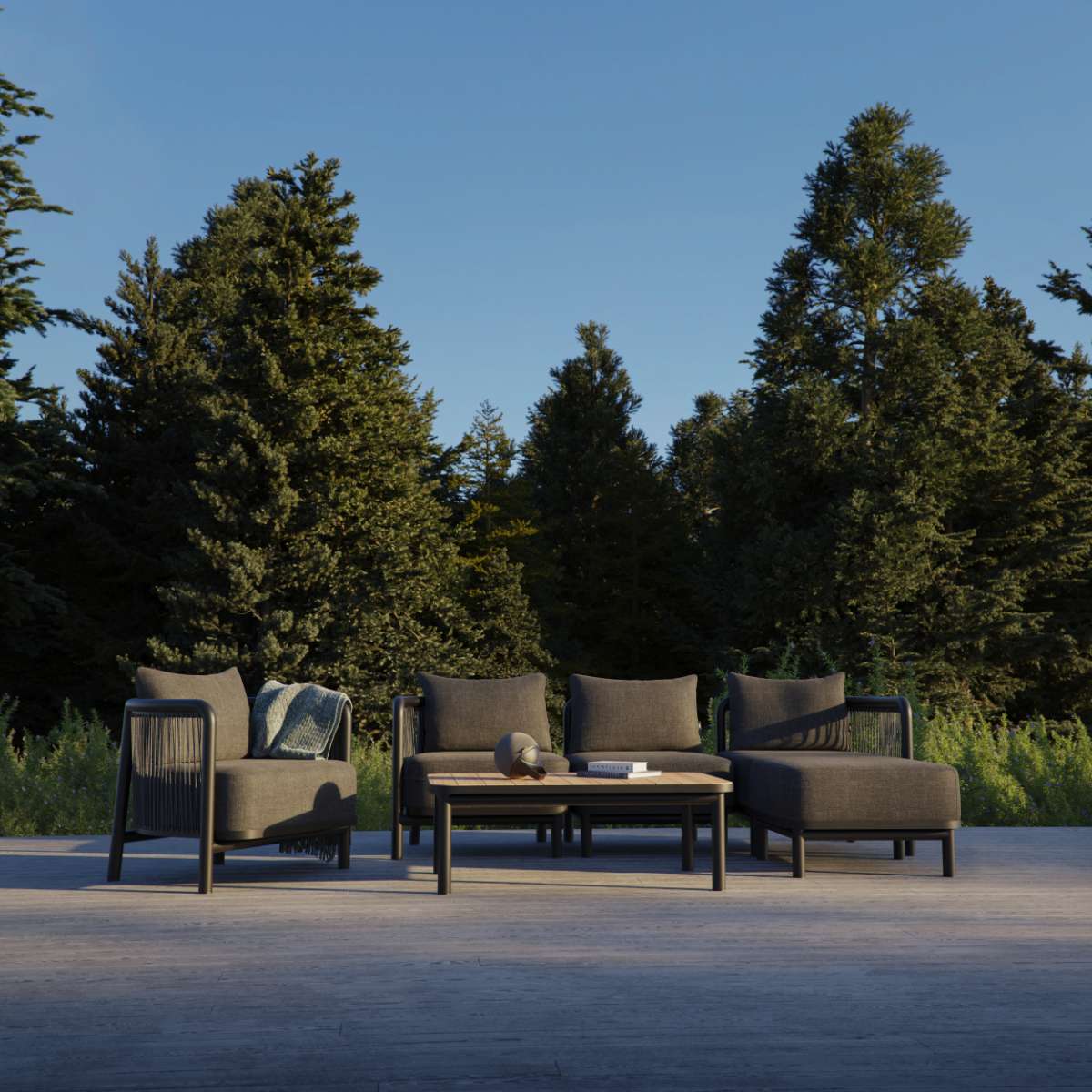 sackit buitenlounge met twee donkergrijze loungefauteuils en een lage tafel op een terras tussen groene bomen voor Scandinavisch buitenleven
