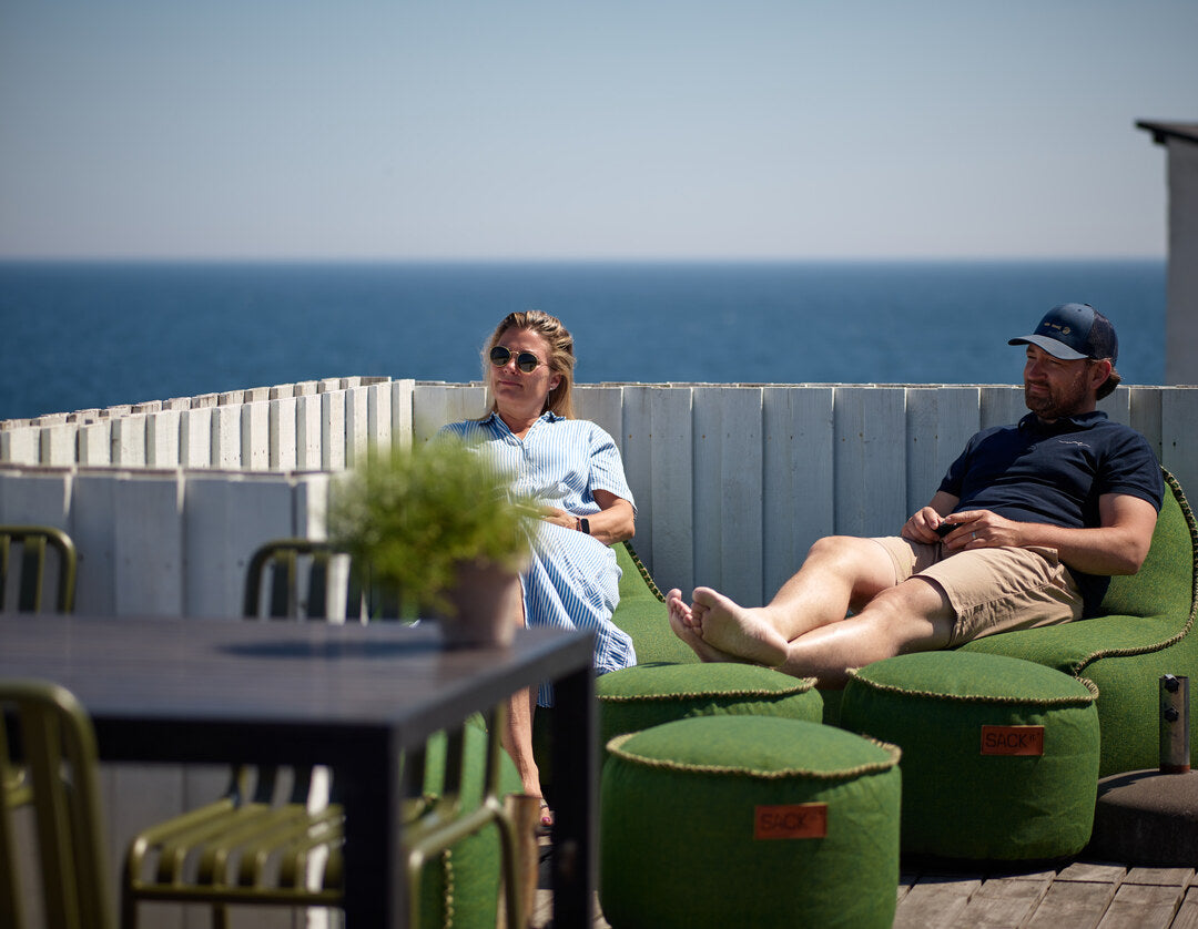 Gasten genieten van het uitzicht over het water vanuit SACKit Cobana zitzakken bij Hotel Klippen