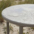 Kirra Dining table Ø110 Ceramic van sackit in een ontspannen loungehoek buiten