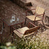 Kirra Patio Lounge Chair in Chestnut van sackit in een ontspannen loungehoek buiten
