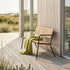 Kirra Patio Bench in olijfgroen van sackit in een buitenomgeving