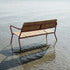 Kirra Patio Bench in Chestnut van sackit buiten bij natuurlijk licht