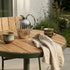 Kirra Café Table in olijfgroen van sackit buiten bij natuurlijk licht