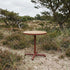 Kirra Café Table in Chestnut van sackit in een ontspannen loungehoek buiten