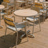Kirra Cafe Table & 2 Kirra Patio Chair in Taupe van sackit in een buitenomgeving