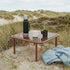 Mollis Coffee Table in Chestnut van sackit in een ontspannen loungehoek buiten